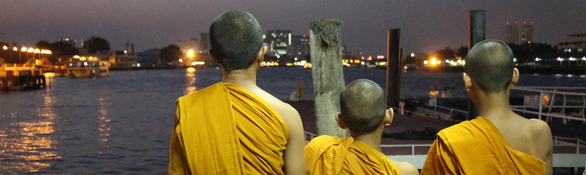 Three young monks and city skyline