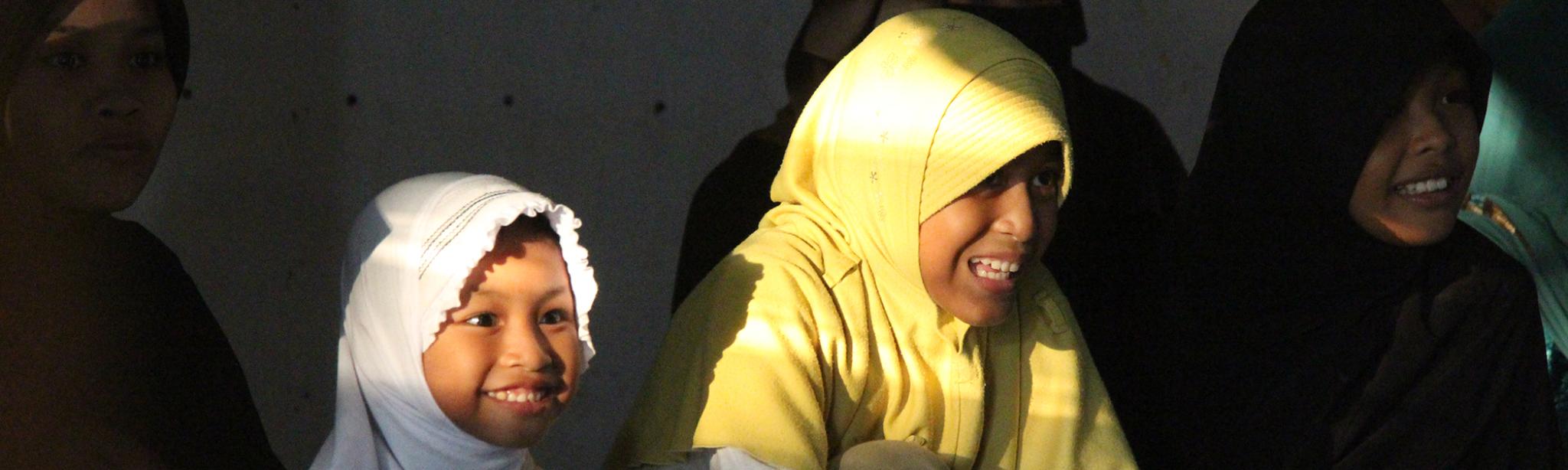Woman in yellow head covering and child