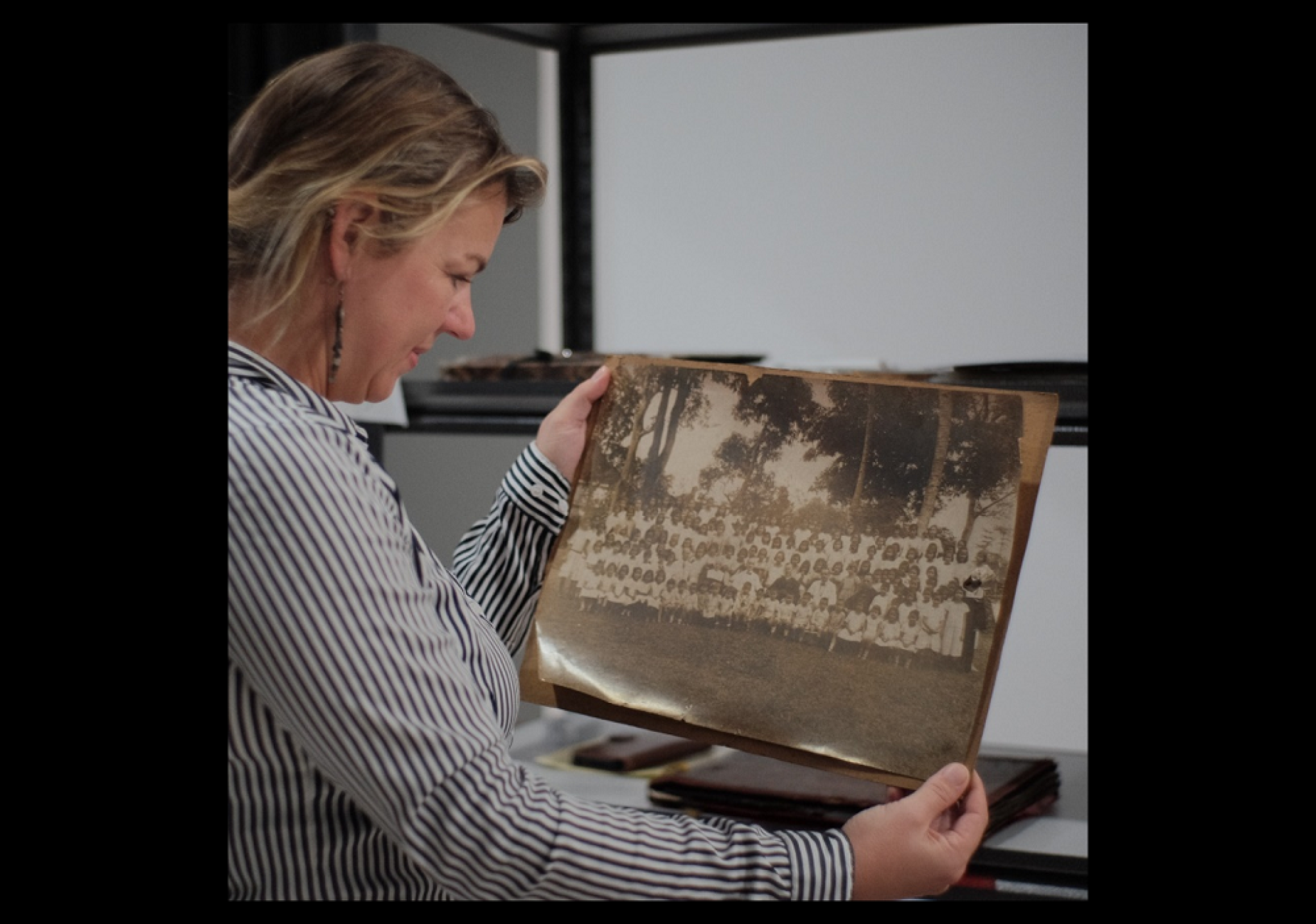 Maaike Derksen examining archival photos