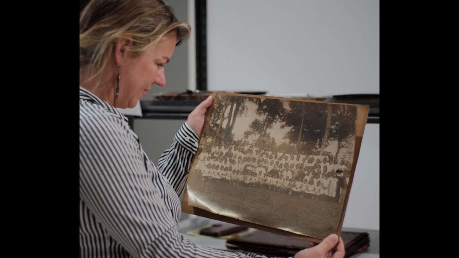 Maaike Derksen examining archival photos